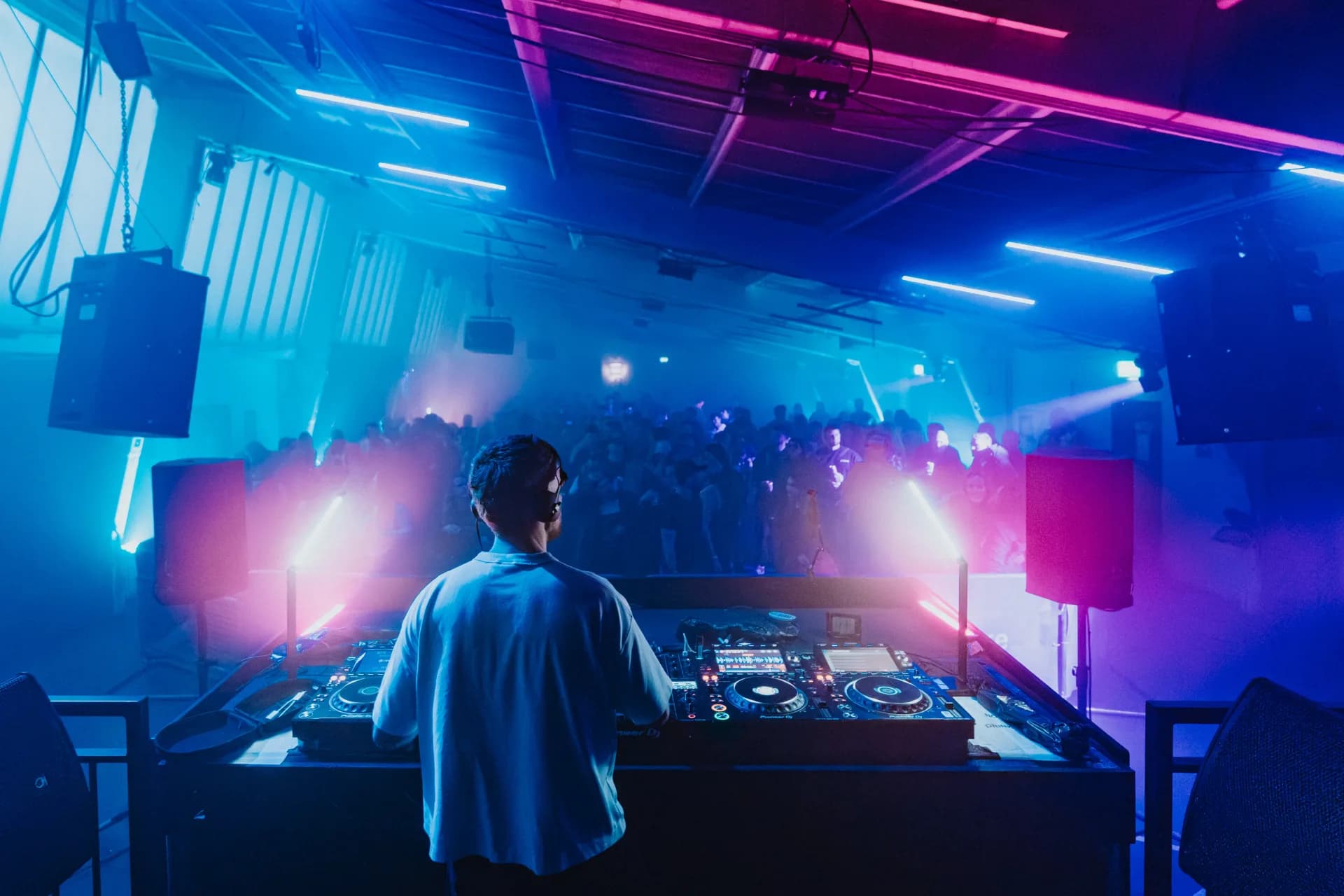 DJ performing a set on Pioneer CDJs in the booth at The Sound Lab, Lincoln